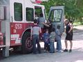 Photograph: [Children explore fire engine at ILD event]