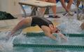 Photograph: [UNT swim member dives into backstroke]