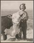 Primary view of [A woman posing with a cow]
