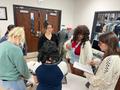 Photograph: [Students reviewing materials relating to a 1780s embroidered coat]