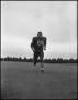 Photograph: [Football Player No. 66 Running on the Field, September 1962]