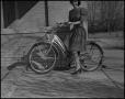 Photograph: [Marie Rather with a bicycle]
