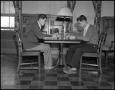 Photograph: [Wayne and Blaine Rideout seated at table]