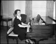 Photograph: [Woman playing the piano]