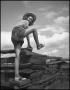 Photograph: [A woman climbing a fence]