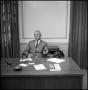Photograph: [William G. Woods seated behind his desk]