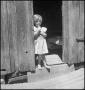 Photograph: [Little Girl in Doorway Dreaming]