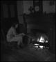 Photograph: [Sitting by fire side]