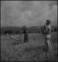 Photograph: [Two farmers harvesting wheat]