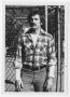 Photograph: [Bill Nelson in front of fence]