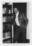 Photograph: [Bill Nelson leaning on bookcase]