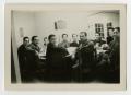 Photograph: [Men and women seated at a table]