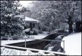 Photograph: [A bridge and house covered in snow]