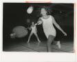 Photograph: [Two women playing badminton in gymnasium]