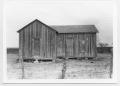 Photograph: [Frontal View of Small Board-and-Batten Home]