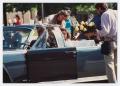 Photograph: [Actors and film crew prepare for motorcade scene in "JFK"]