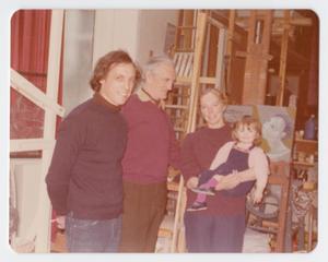 [John Hutton with a Man, Woman, and Child in His Studio]
