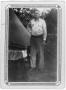 Photograph: [Man stands by a CCC camp tent ]
