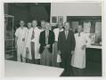 Photograph: [Dr. Chauncey D. Leake and Seven Colleagues at a Medical Exhibition]