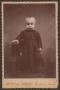 Photograph: [Photograph of an Unknown Child in Dark Clothing]