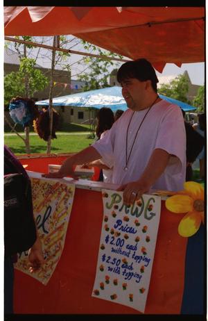 [Individuals at food booth at PACfest]