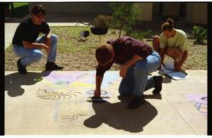 [Individuals creating sidewalk chalk art at PACfest]