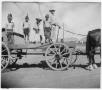 Photograph: Allen Hall on wagon with children dressed as Indians
