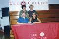 Photograph: [Abby Davis signing volleyball scholarship agreement]
