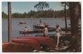 Postcard: [Postcard of Young Women Standing by Canoes and Swimming at Camp Fern…