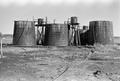 Photograph: [Wooden Oil Tanks at Ada Belle Oil Field #2]