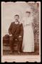 Photograph: [Portrait of an Unknown Couple in Wedding Attire with Hats]