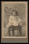 Photograph: [Portrait of a Child on a Wicker Chair]