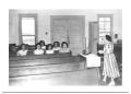 Photograph: [Group of Girls Sitting Together in Church Pews]