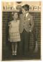 Photograph: Photo of boy and girl in front of fireplace