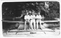 Photograph: [George A. Hill, Jr. with sitting with unidentified men near fountain]