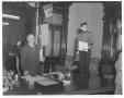 Photograph: [The "Phillip Morris Midget" standing on a desk next to Governor Jest…