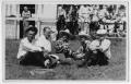Photograph: [Ruth Roach sitting in the grass with friends]