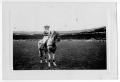 Photograph: [Ruth Roach astride a horse in an arena in Paris, France]