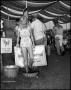Photograph: [Young Girl Stomping Grapes at the Wine-Making Booth]