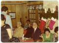 Photograph: [Men and Women Seated at Tables During Christmas Party]