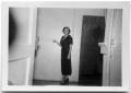 Photograph: Woman standing in a hallway.