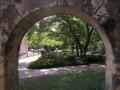 Photograph: Grounds of the Alamo through an archway
