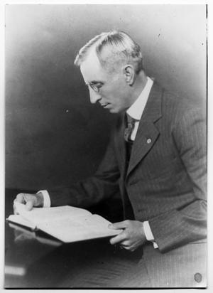 Portrait of F.H Farwell reading a book