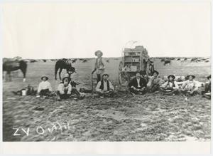 [Photograph of Men Sitting Behind a Chuck Wagon]