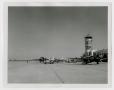 Photograph: [Photograph of Airplanes in Front of Control Tower]