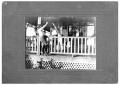 Photograph: [John A. Matthews, Jr. and Dogs on a Porch]