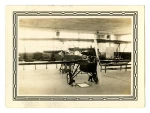 [Photograph of an Old Airplane in a Cadet Classroom]