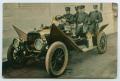 Postcard: [Postcard of Fire Fighters in an Automobile]
