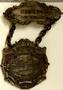 Physical Object: [Two pieces medals connected by chain reads: "MEMBER C.R.A. OF T." on…