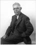 Photograph: [Albert Peyton George seated, with his left hand in his pants pocket]